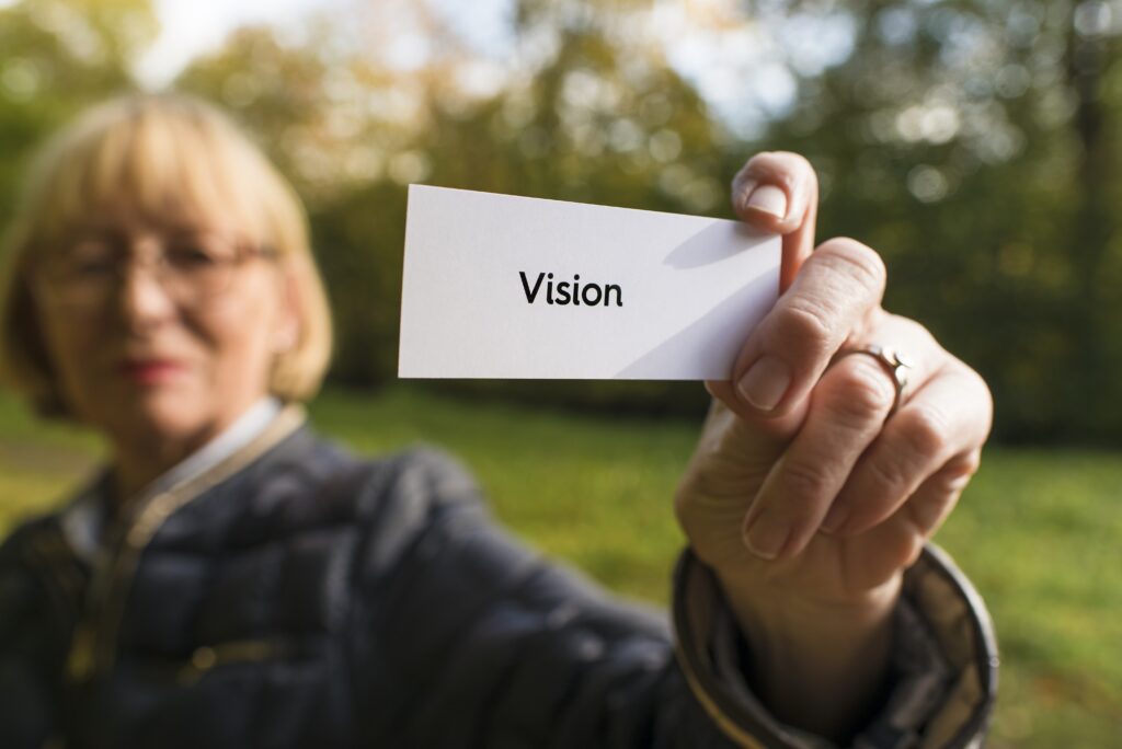 Kvinna som håller lapp med ordet vision